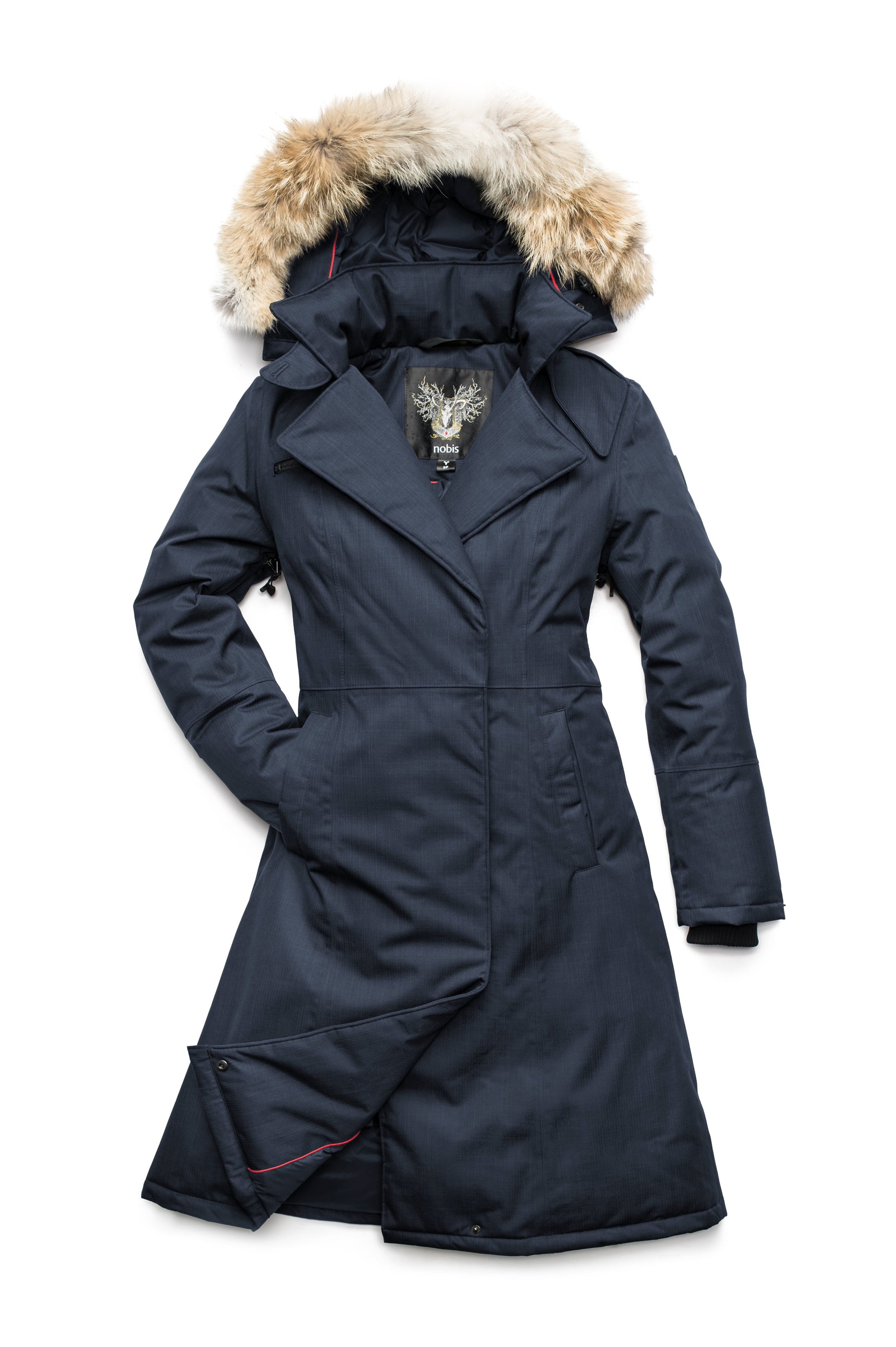 Long calf length women's trench inspired parka with removable fur trim around the hood and an asymetric closure in Navy