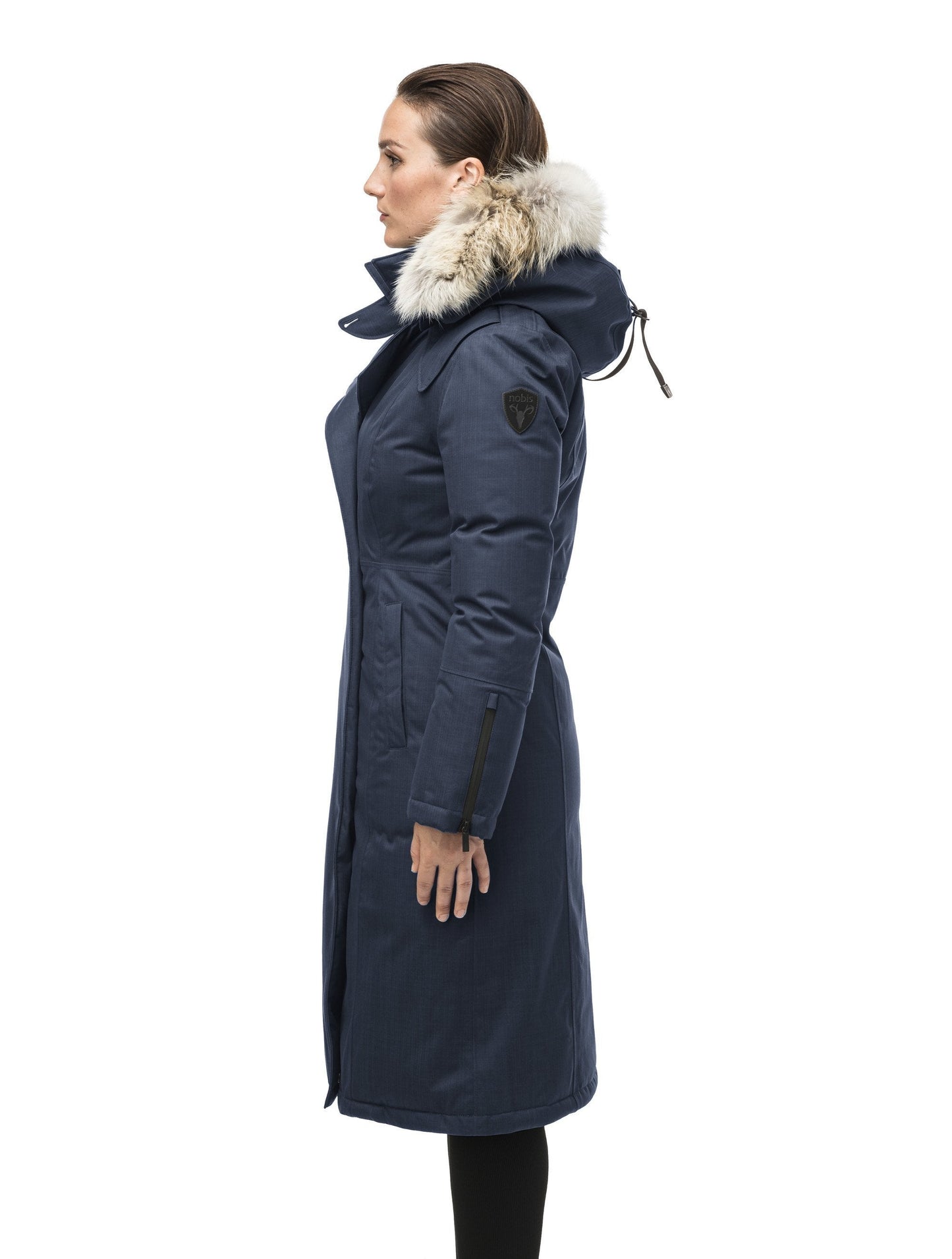 Long calf length women's trench inspired parka with removable fur trim around the hood and an asymetric closure in Navy