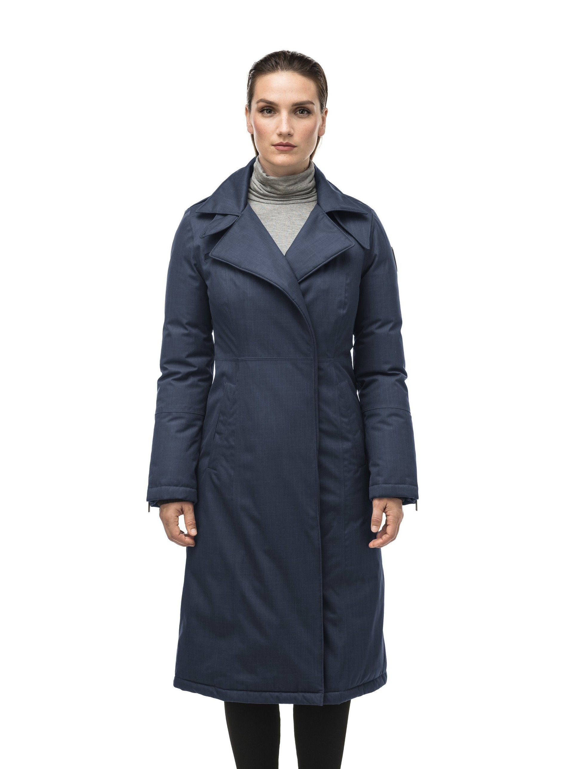 Long calf length women's trench inspired parka with removable fur trim around the hood and an asymetric closure in Navy