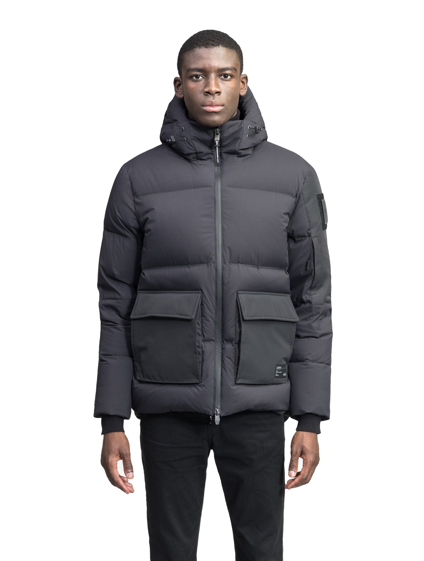 Supra Men's Performance Puffer in hip length, Technical Taffeta and 3-Ply Micro Denier fabrication, Premium Canadian White Duck Down insulation, non-removable down filled hood, centre front two-way zipper, flap pockets at waist, and zipper pocket at left bicep, in Black