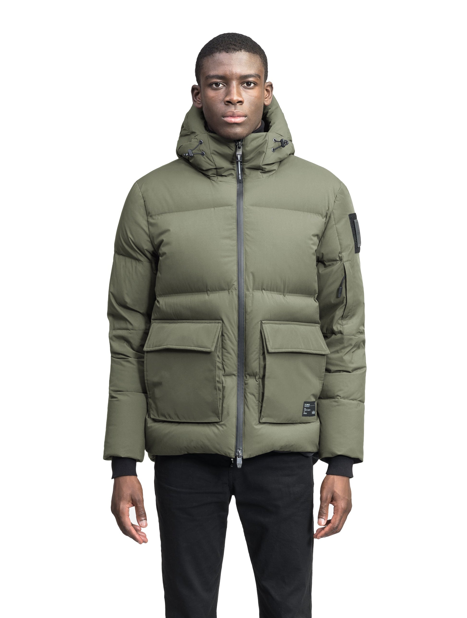 Supra Men's Performance Puffer in hip length, Technical Taffeta and 3-Ply Micro Denier fabrication, Premium Canadian White Duck Down insulation, non-removable down filled hood, centre front two-way zipper, flap pockets at waist, and zipper pocket at left bicep, in Clover