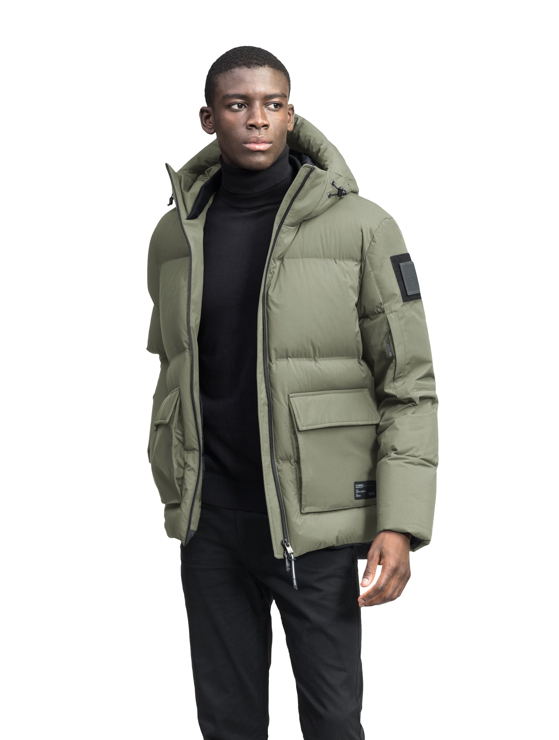 Supra Men's Performance Puffer in hip length, Technical Taffeta and 3-Ply Micro Denier fabrication, Premium Canadian White Duck Down insulation, non-removable down filled hood, centre front two-way zipper, flap pockets at waist, and zipper pocket at left bicep, in Clover