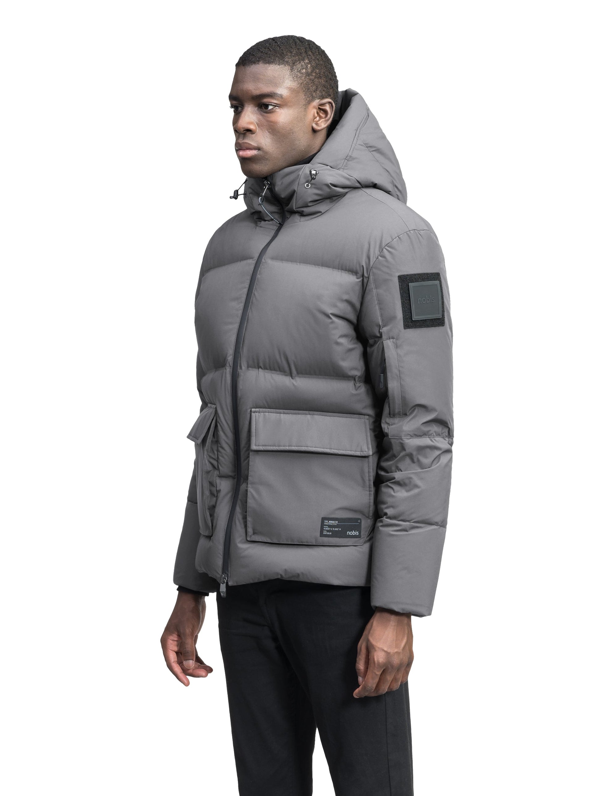 Supra Men's Performance Puffer in hip length, Technical Taffeta and 3-Ply Micro Denier fabrication, Premium Canadian White Duck Down insulation, non-removable down filled hood, centre front two-way zipper, flap pockets at waist, and zipper pocket at left bicep, in Concrete