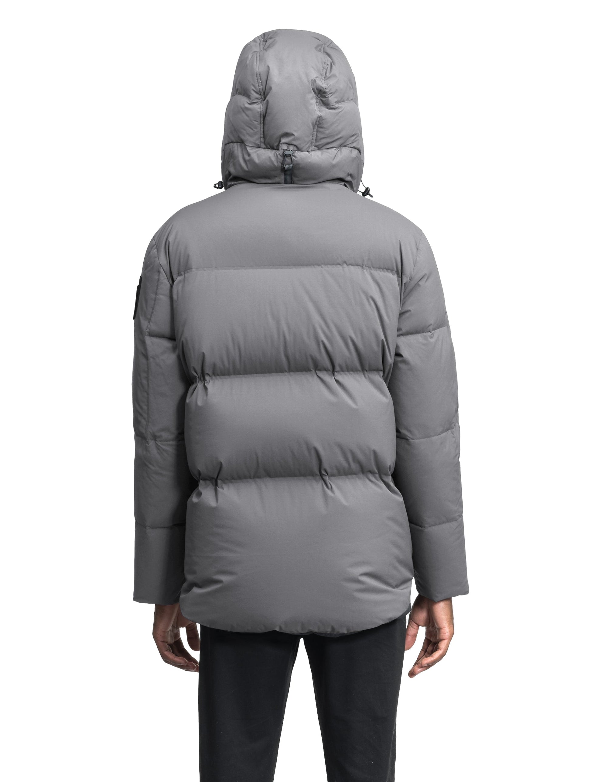 Supra Men's Performance Puffer in hip length, Technical Taffeta and 3-Ply Micro Denier fabrication, Premium Canadian White Duck Down insulation, non-removable down filled hood, centre front two-way zipper, flap pockets at waist, and zipper pocket at left bicep, in Concrete