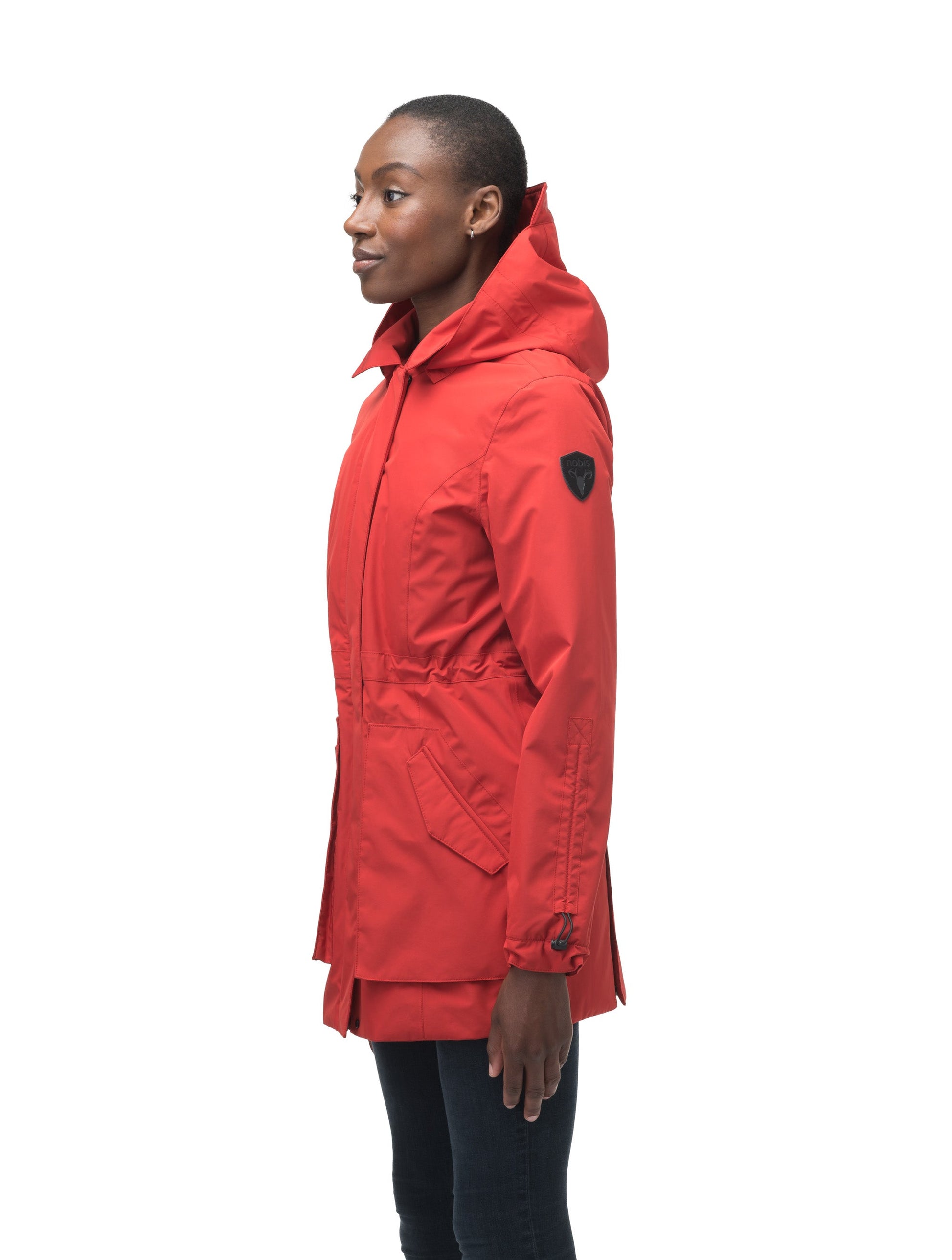 Women's thigh length raincoat with collar and non-removable hood in Vermillion