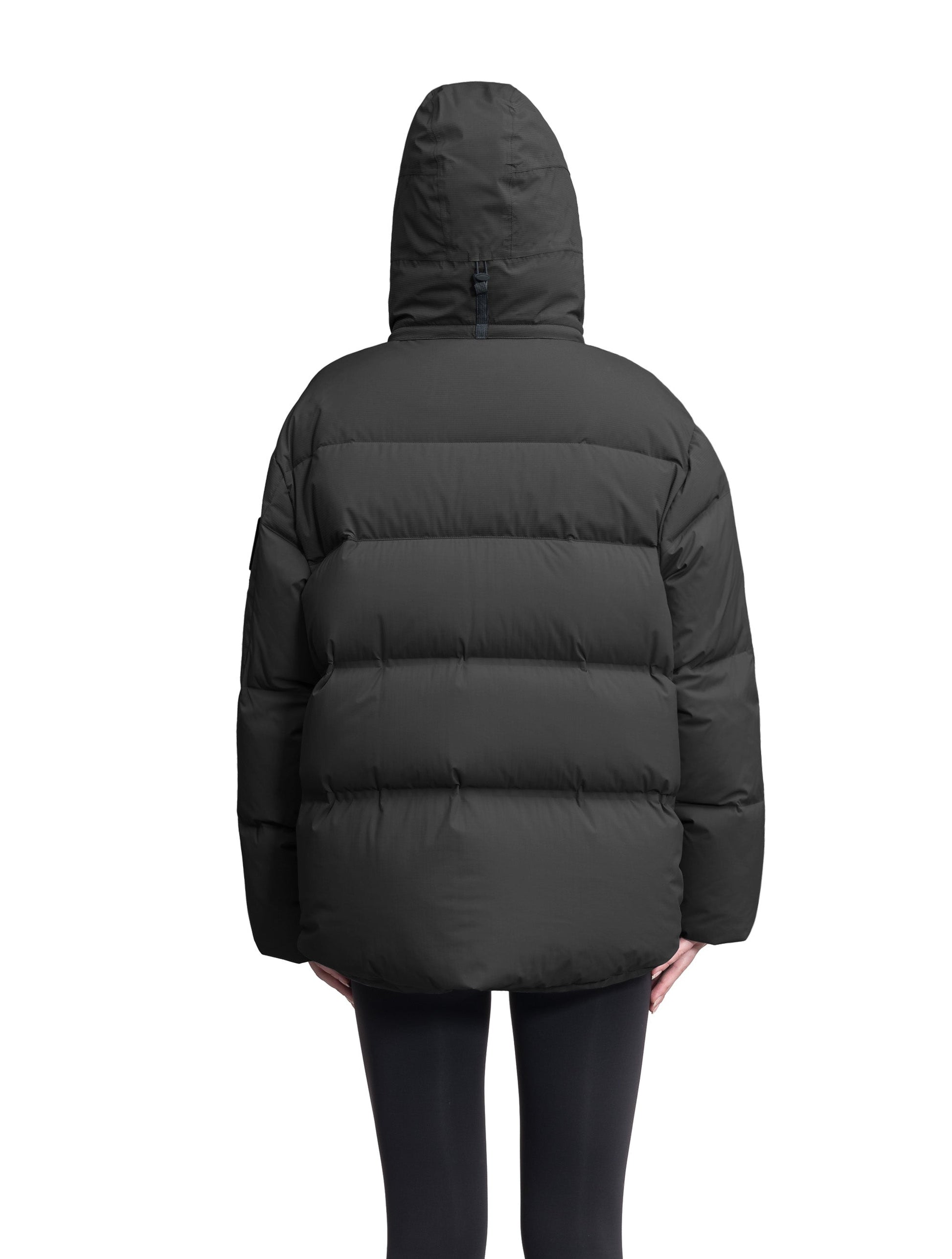 Una Ladies Performance Puffer in hip length, Technical Taffeta and Durable Stretch Ripstop fabrication, Premium Canadian White Duck Down insulation, removable down filled hood, centre front two-way zipper, and side-entry pockets at waist, in Black