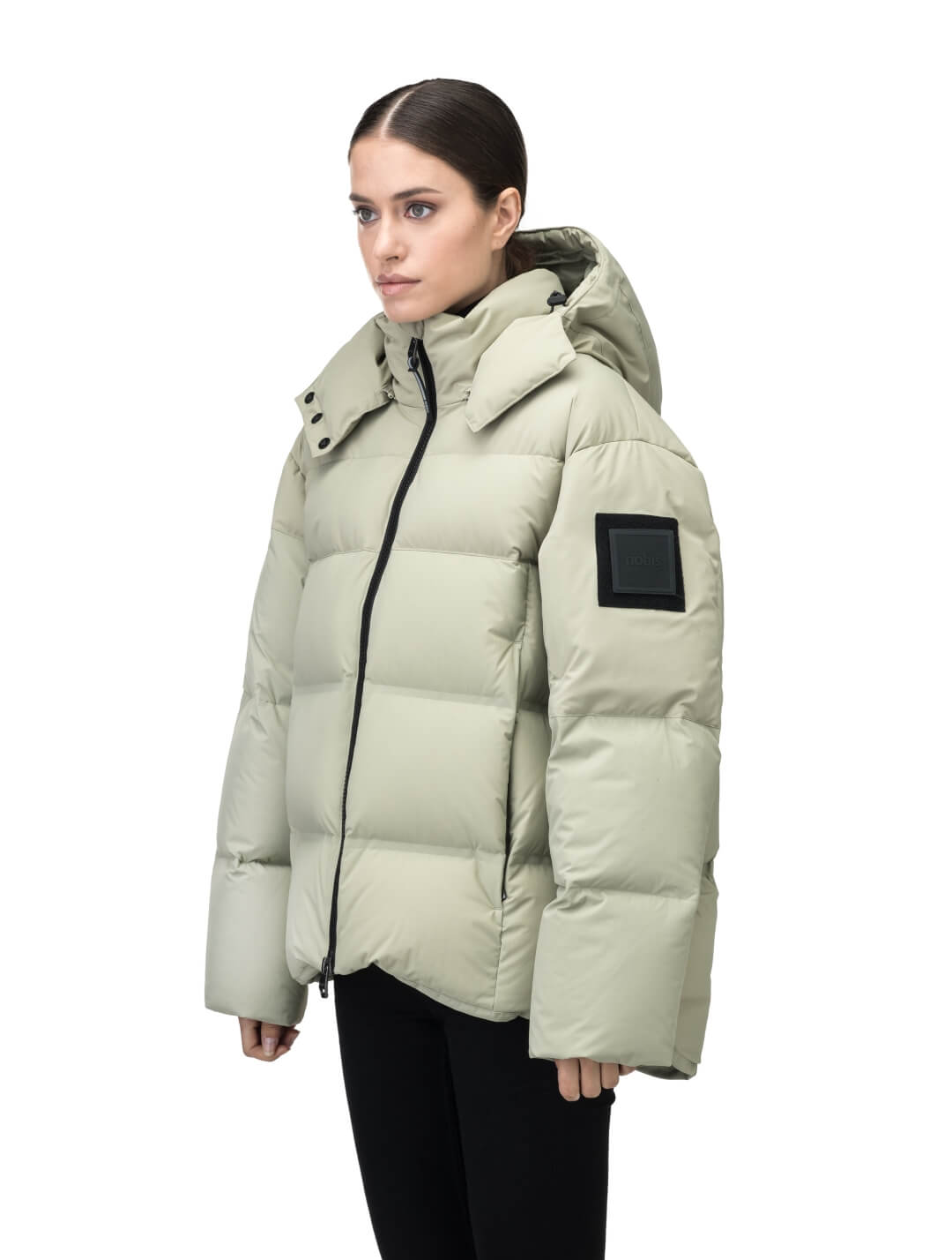 Una Ladies Performance Puffer in hip length, Technical Taffeta and Durable Stretch Ripstop fabrication, Premium Canadian White Duck Down insulation, removable down filled hood, centre front two-way zipper, and side-entry pockets at waist, in Tea