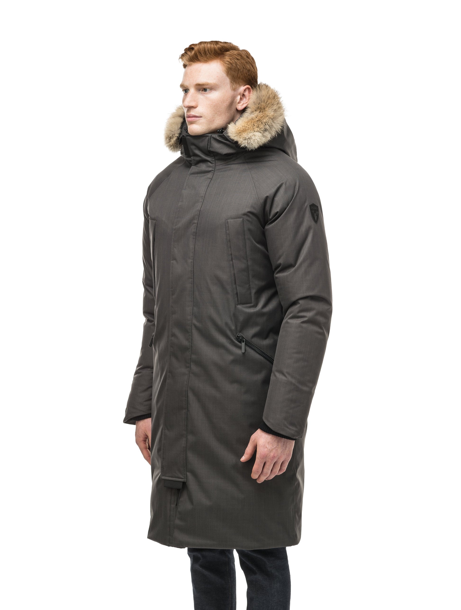 This ankle length men's down filled parka doubles as an over coat with a removable fur trim on the hood in Steel Grey