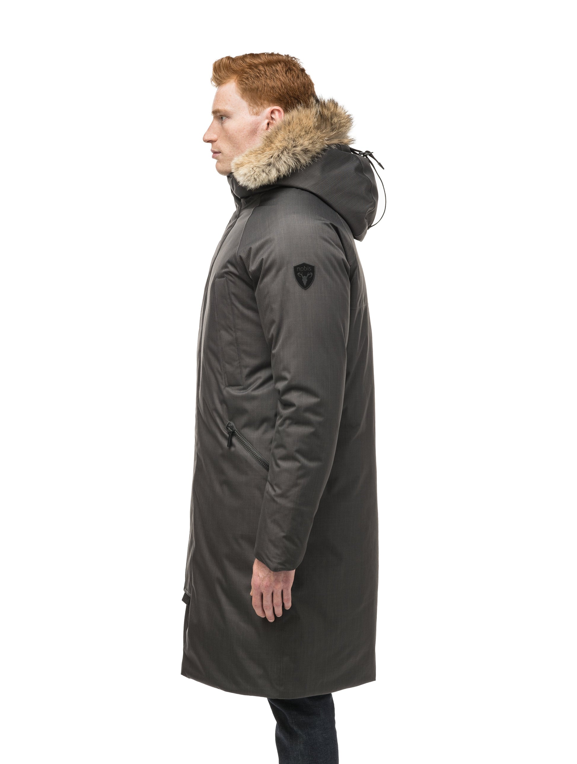 This ankle length men's down filled parka doubles as an over coat with a removable fur trim on the hood in Steel Grey