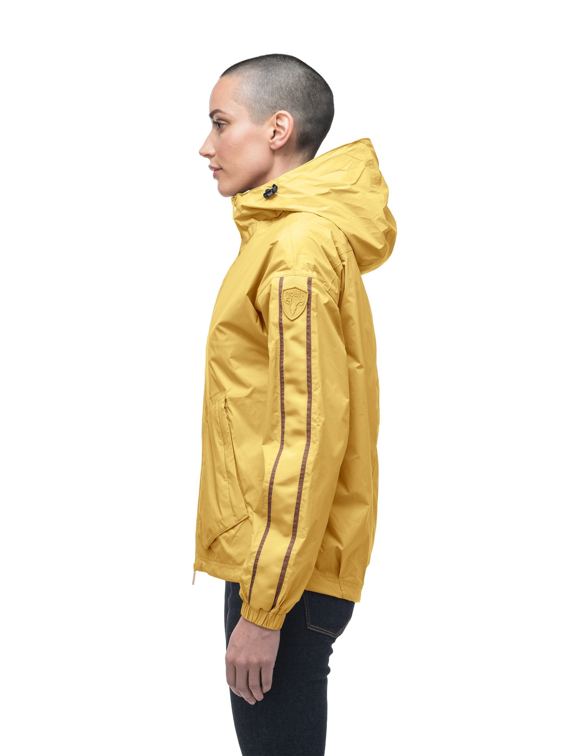 Women's waist length windbreaker with hood in Citron