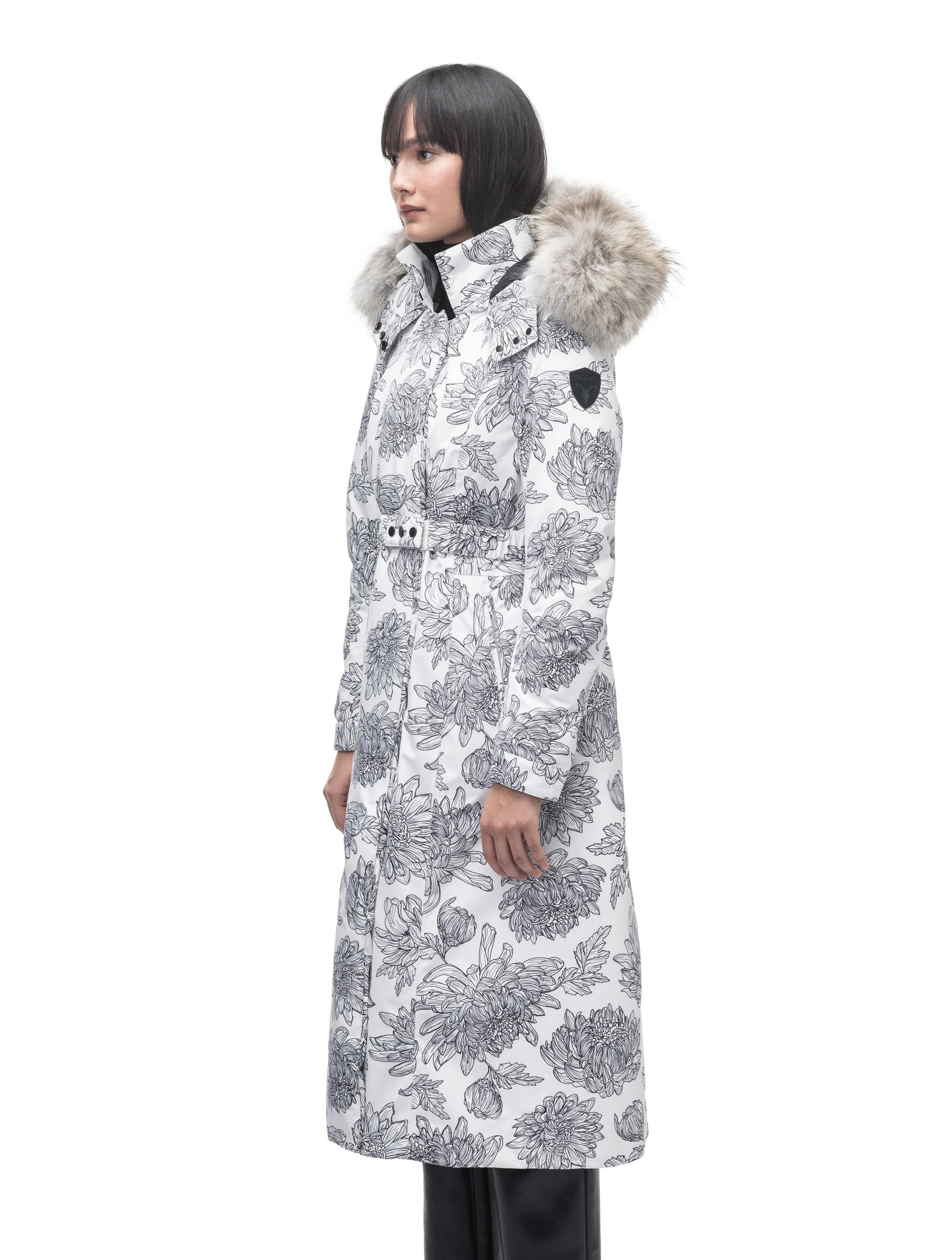 Celest Ladies Duster Parka in knee length, Canadian duck down insulation, removable hood and coyote fur trim, with adjustable belt, in White Floral