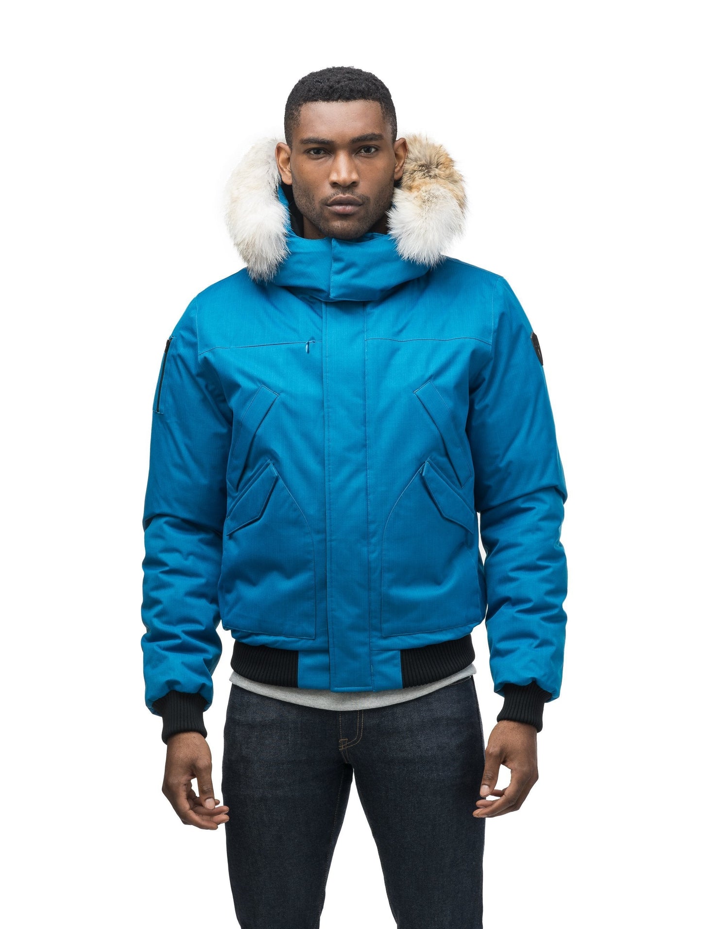 Men's classic down filled bomber jacket with a down filledÃ‚Â hood that features a removable coyote fur trim and concealed moldable framing wire in Sea Blue