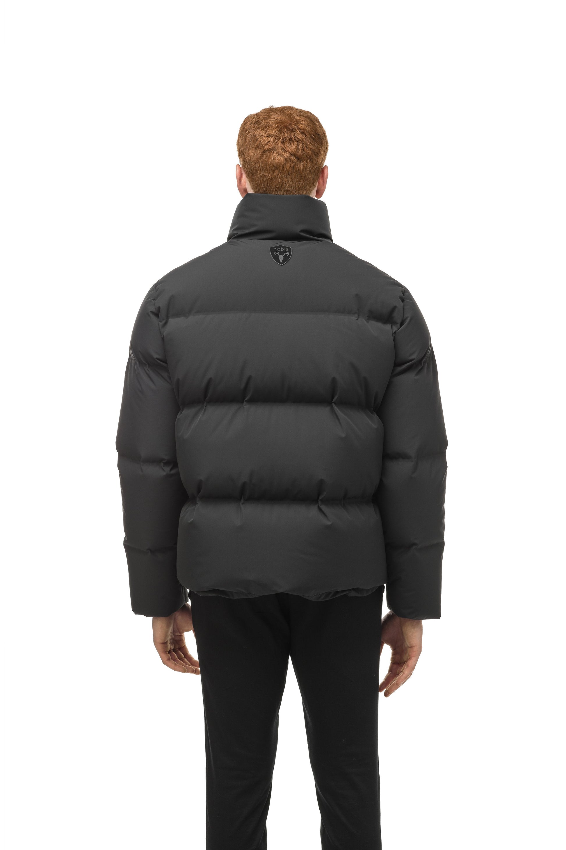 Men's puffer jacket with a minimalist modern design; featuring graphic details like oversized tonal branding, an exposed zipper, and seamless puffer channels in Black