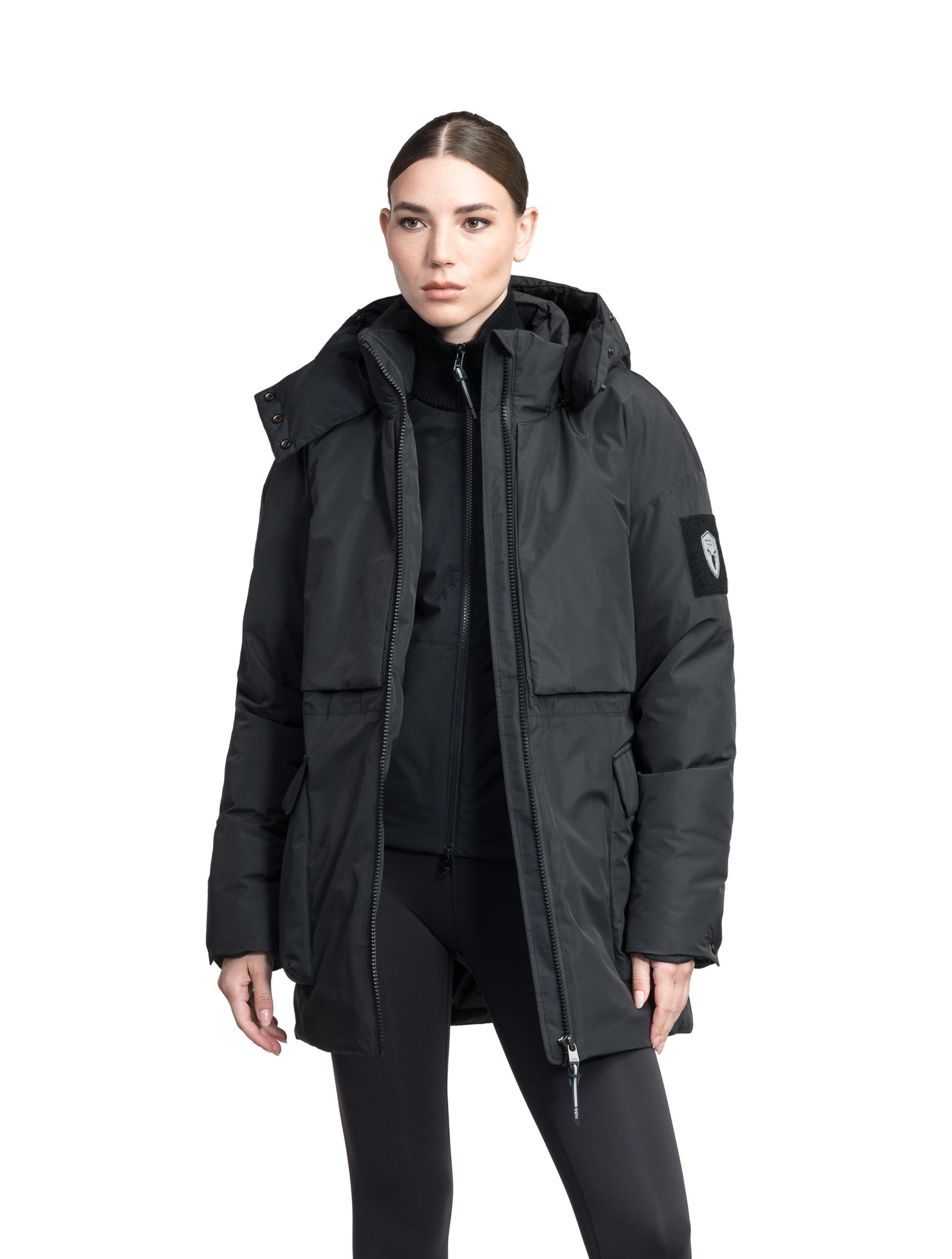 Haelyn Ladies Short Utility Parka in thigh length, 3-Ply Micro Denier fabrication, Premium Canadian White Duck Down insulation, removable down-filled hood, two-way centre front zipper, hidden adjustable cord at waist, adjustable snap cuffs, and four exterior patch pockets at front, in Black