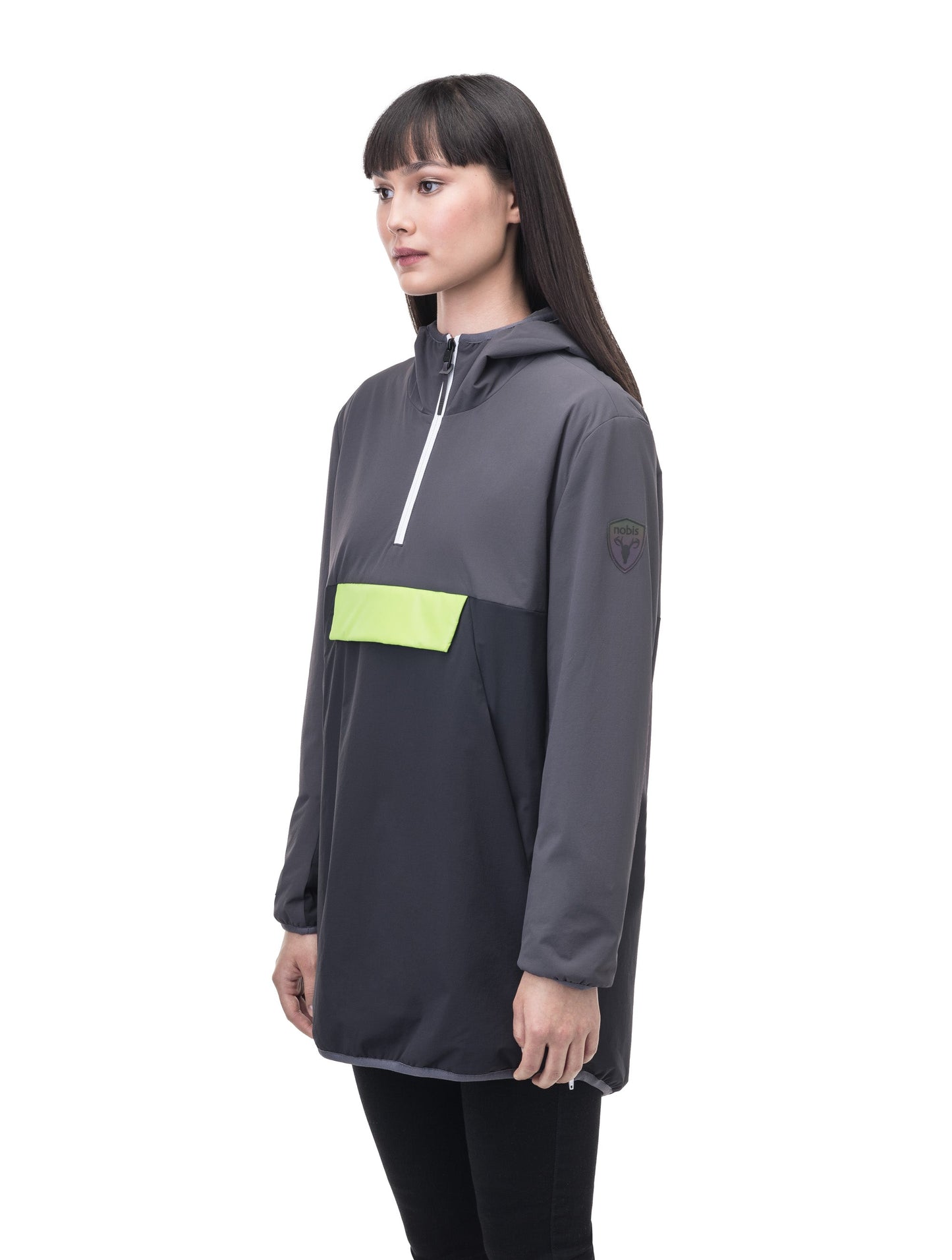 Unisex thigh length hooded anorak with vertical zipper along collar, side zippers along torso, and centre zipper pouch with a reflective flap, in Steel Grey/Black