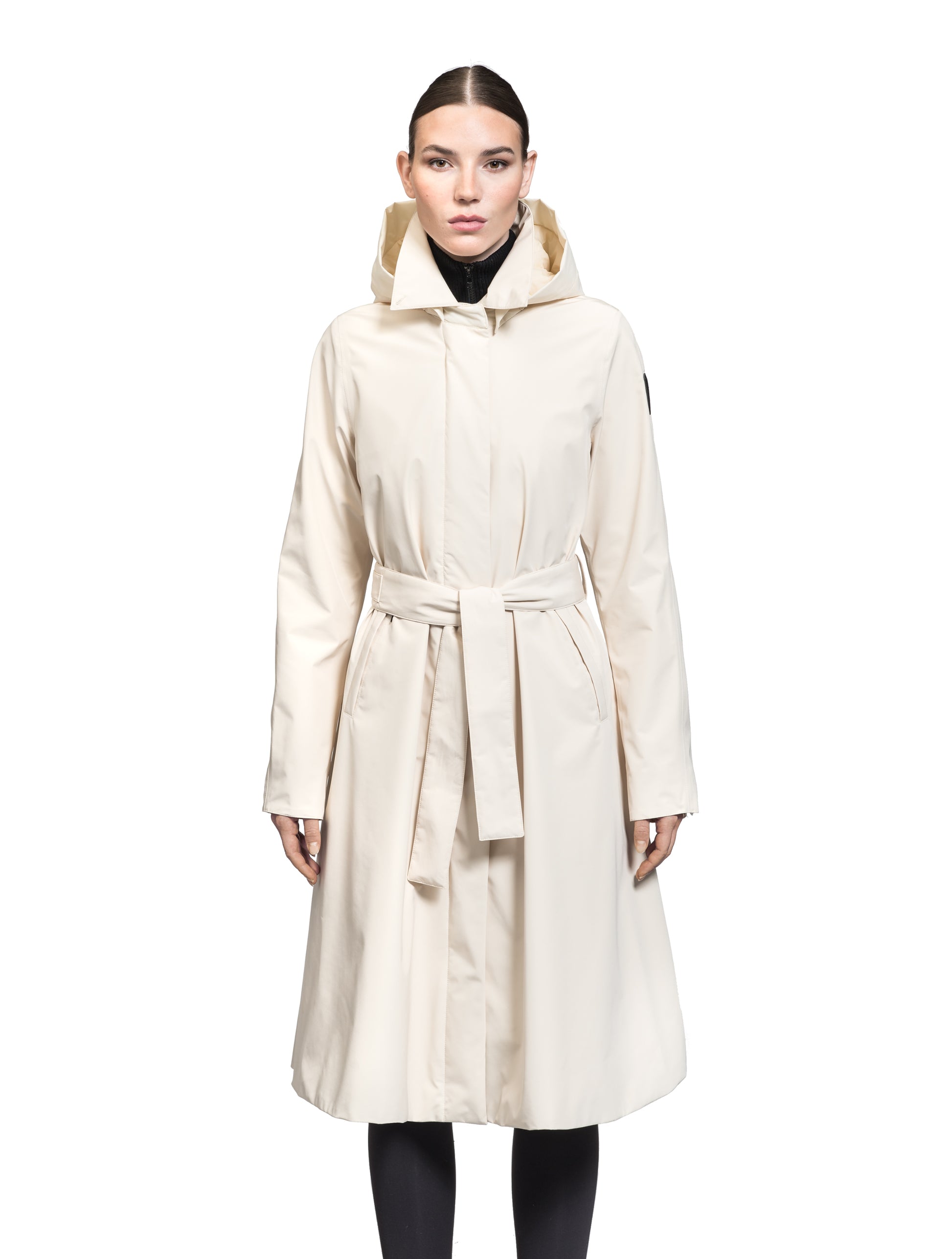 Ivy Ladies Tailored Trench Coat in knee length, 3-Ply Micro Denier fabrication, retractable non-removable hood, front wind flap with snap button closure, removable belt, and adjustable snap cuffs, in Wheat