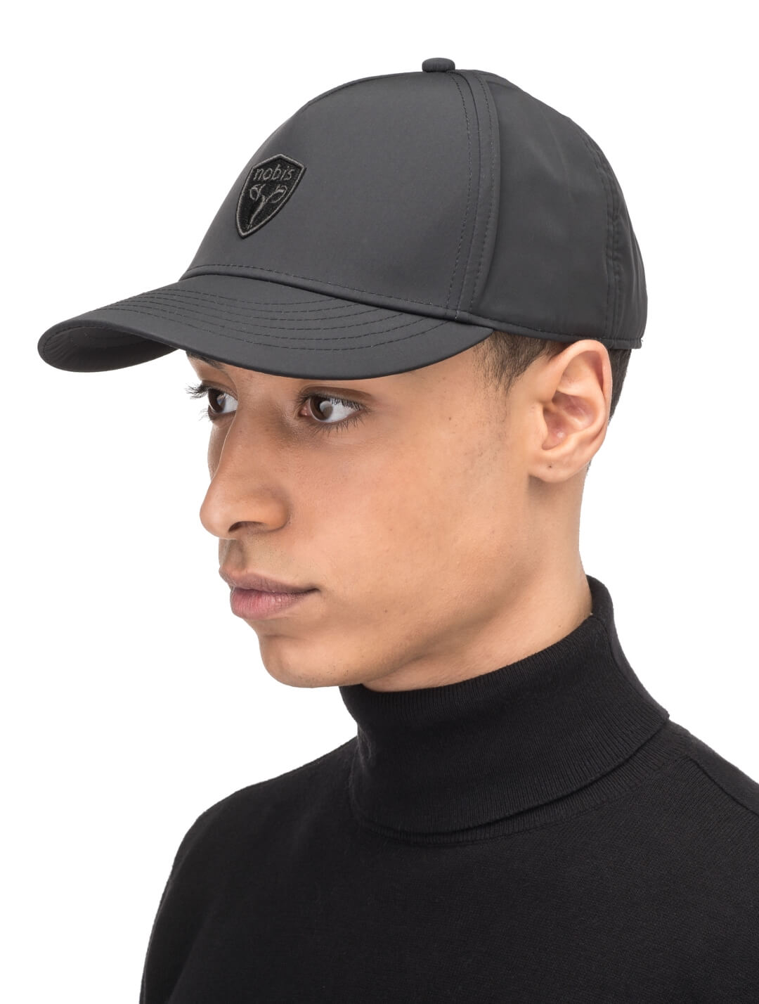 Satine Adjustable Cap in 5-panel construction, mid height crown, curved peak brim, and adjustable strap closure, in Black