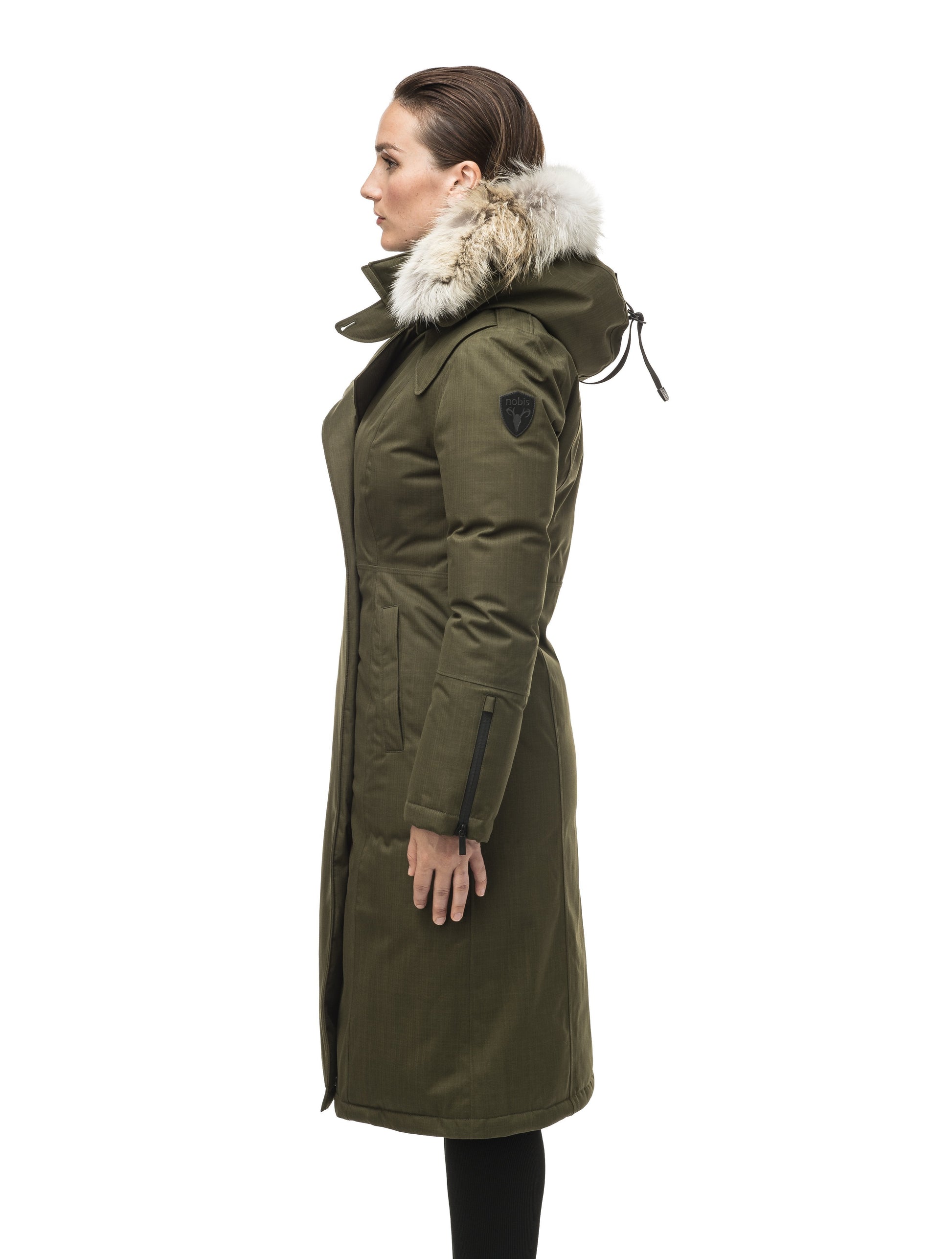 Long calf length women's trench inspired parka with removable fur trim around the hood and an asymetric closure in Fatigue